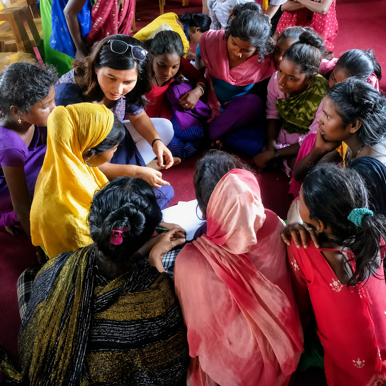 EmpowerHER: Rights, Protection and Hope Women and girls in bright clothes gathered closely together