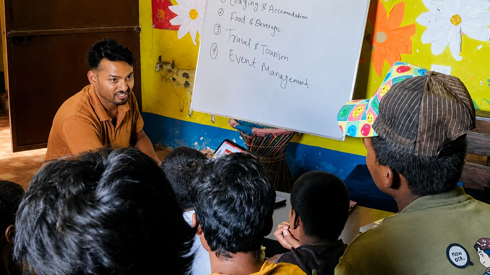 Facilitator and community members at a workshop with a whiteboard