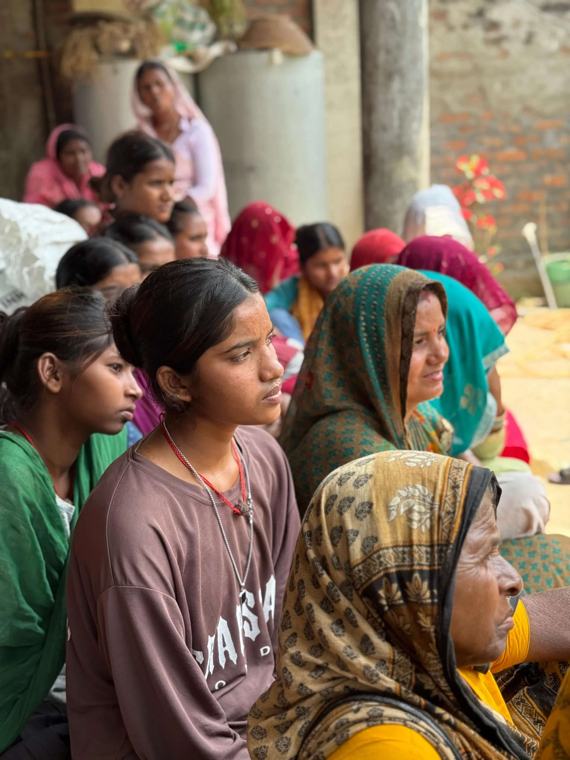 Girls and women listening closely at a community session
