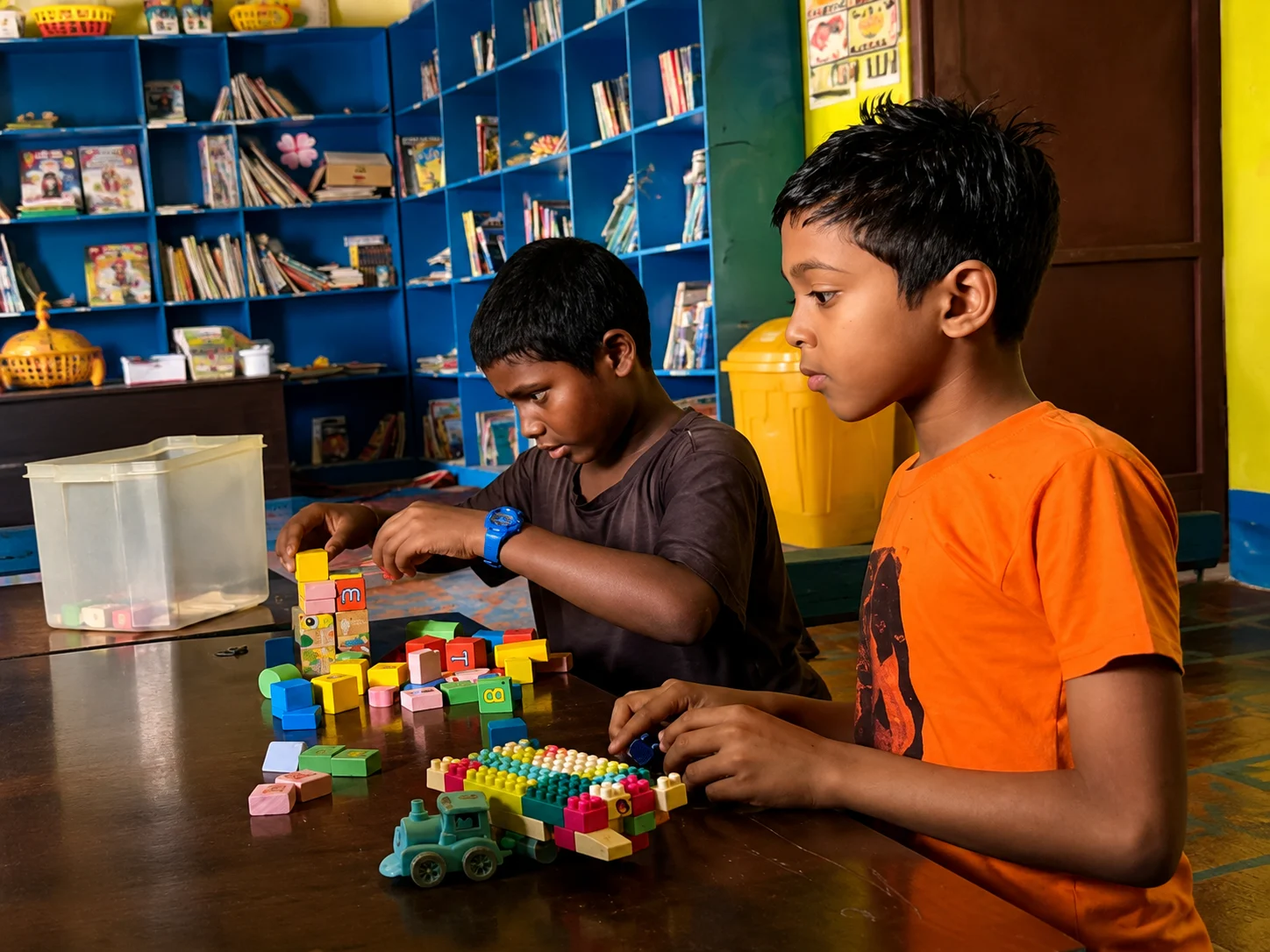 Learning beyond the classroom Two boys building with colourful wooden blocks in front of a bookshelf