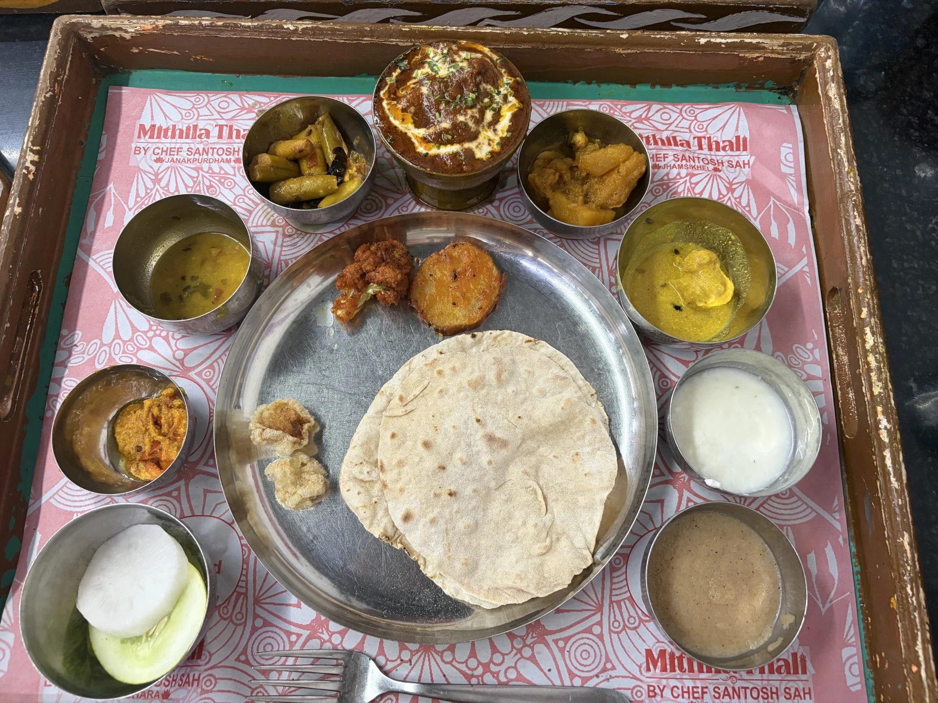 Traditional Nepali thali with flatbread, curries and rice