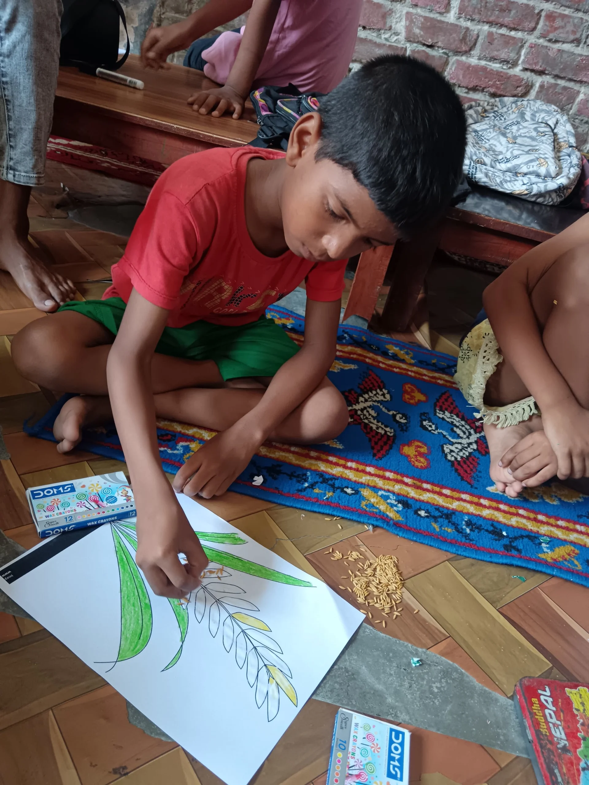 Boy drawing on a rug on the floor