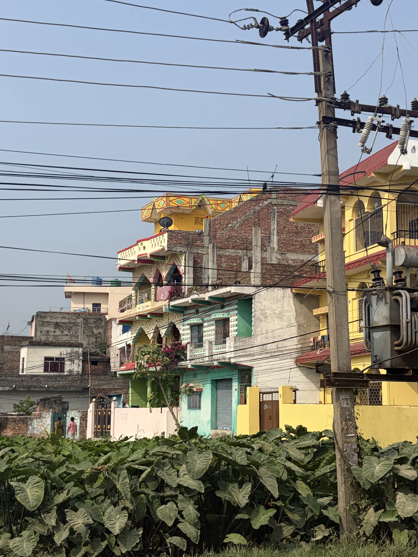Brightly painted buildings behind electricity wires in a Nepali town