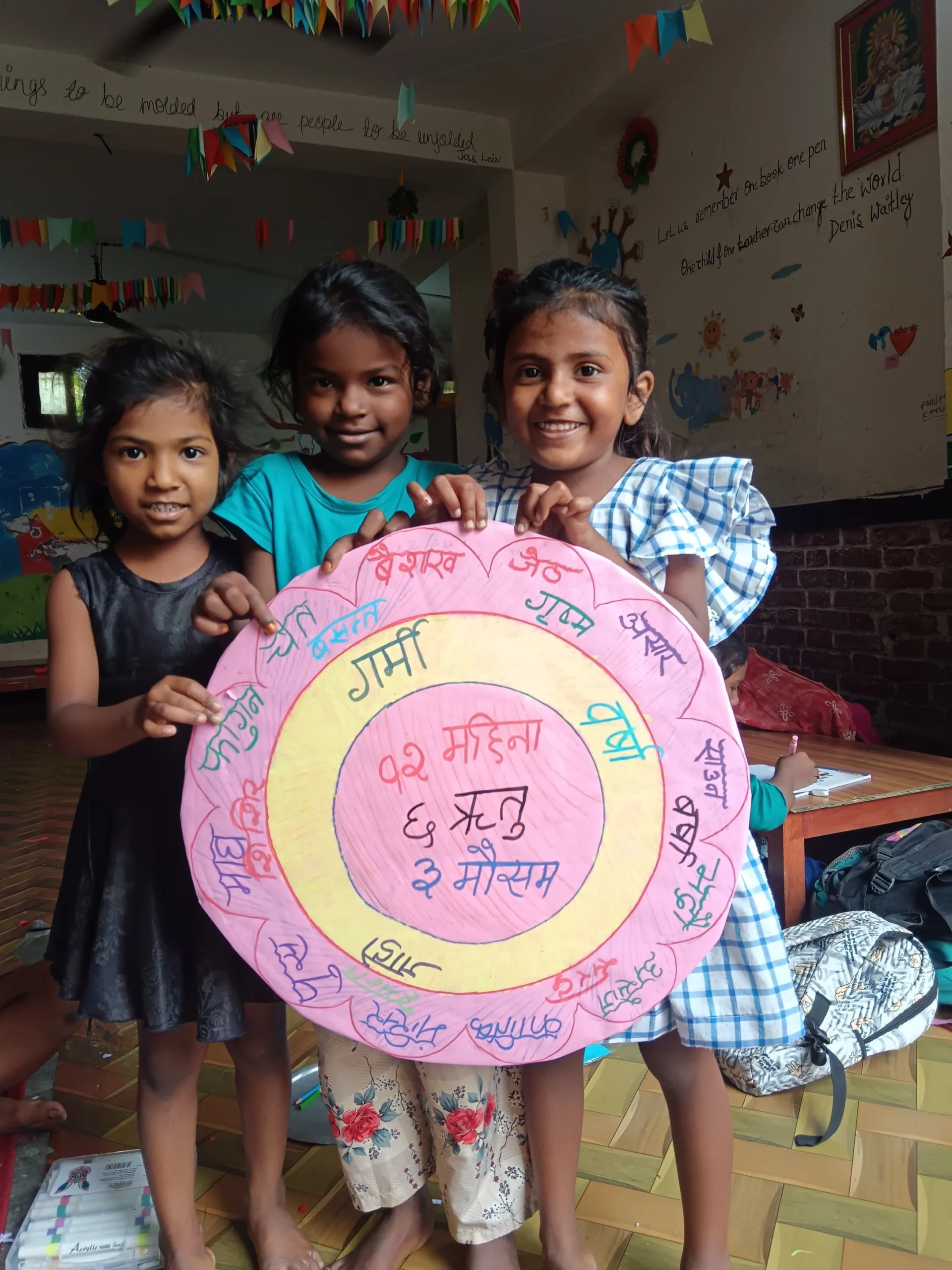 What Happens Next? Three young girls holding a hand-made decorated circle